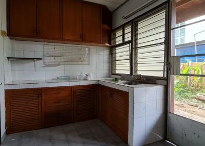 Spacious kitchen with wooden cabinets and large window