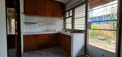 Spacious kitchen with wooden cabinets and large window