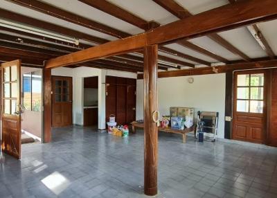 Spacious living room with wooden beams and large windows