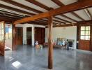 Spacious living room with wooden beams and large windows