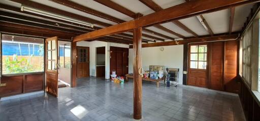 Spacious living room with wooden beams and large windows