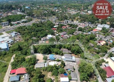 Aerial view of a residential area with property boundaries marked for sale