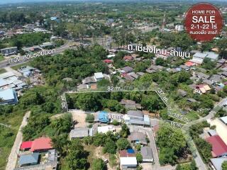 Aerial view of a residential area with property boundaries marked for sale