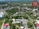 Aerial view of a residential area with property boundaries marked for sale