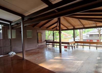 Spacious and well-lit wooden living room interior with open layout