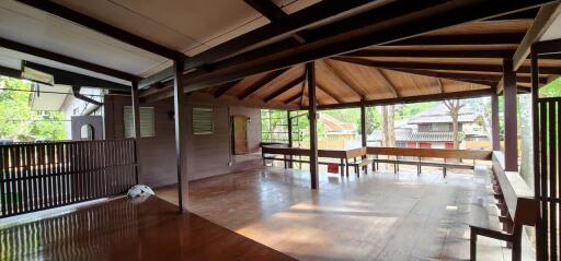 Spacious and well-lit wooden living room interior with open layout