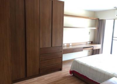 Modern bedroom with large wardrobe and wooden features