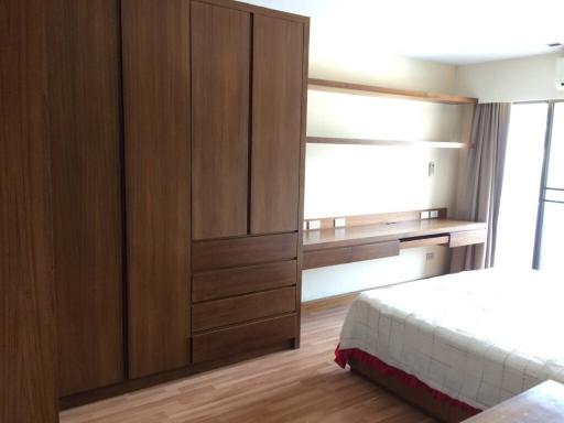 Modern bedroom with large wardrobe and wooden features