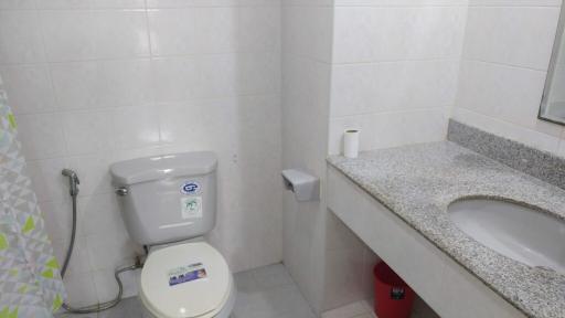 Modern bathroom with white tiles and granite countertop