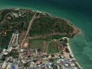 Aerial view of a coastal area with varied terrain and infrastructure