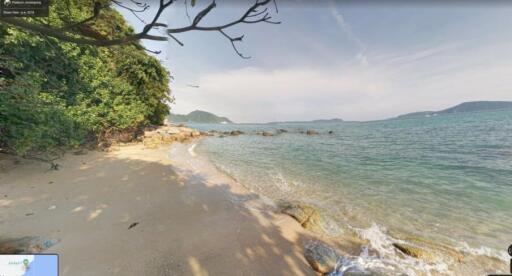 Secluded beachfront with clear blue water and sandy shore