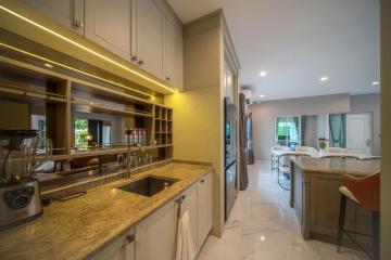 Modern kitchen with marble countertops and LED lighting