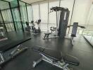 Modern home gym with exercise equipment and panoramic windows