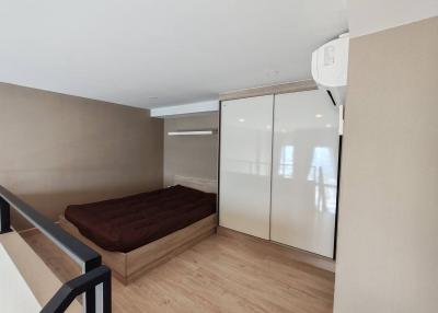 Modern bedroom with large wardrobe and air conditioning unit