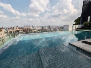 Luxury rooftop swimming pool with city skyline view