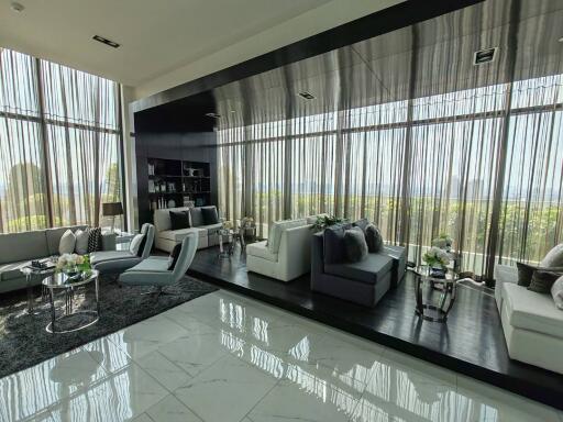 Spacious and modern living room with large windows and ample natural light