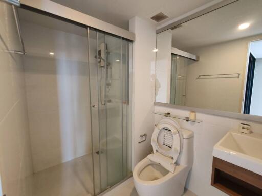 Modern bathroom with glass shower enclosure and clean fixtures