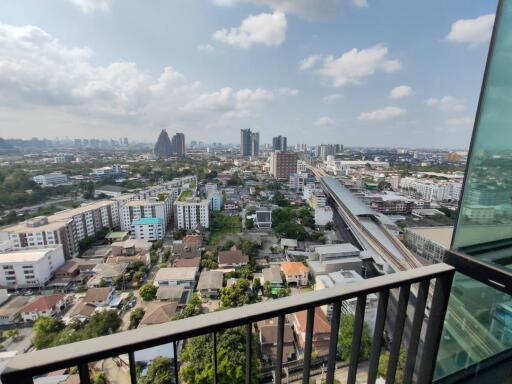 Cityscape view from high-rise apartment balcony