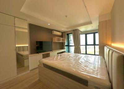 Modern bedroom with ample lighting and contemporary furniture