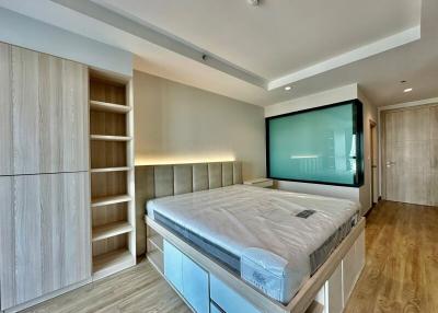 Modern bedroom with large bed and built-in wardrobe