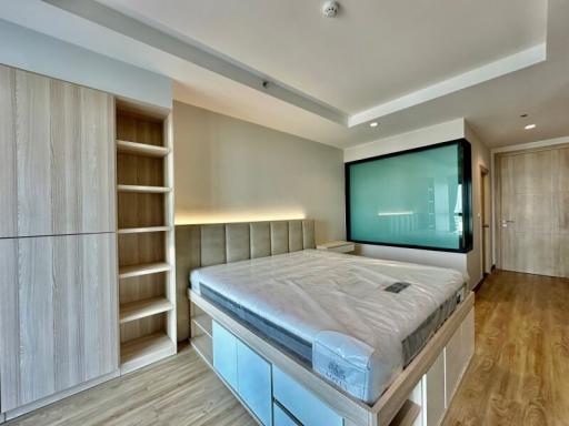 Modern bedroom with large bed and built-in wardrobe
