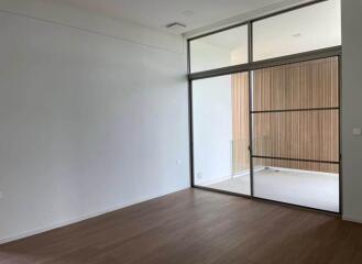 Modern bedroom with large sliding glass door and spacious built-in wardrobe