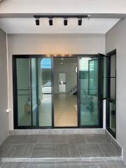 Elegant home entrance with glass doors and modern lighting