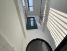 Modern bright atrium with staircase and large windows in a contemporary building