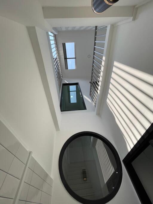 Modern bright atrium with staircase and large windows in a contemporary building