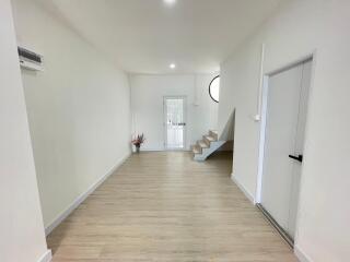 Spacious and modern living room with stairs and ample natural light