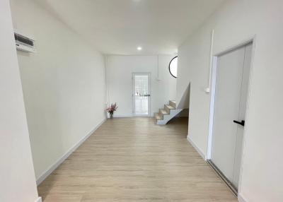 Spacious and modern living room with stairs and ample natural light