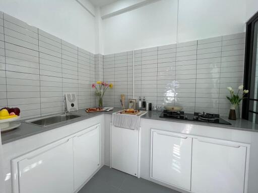 Modern kitchen with stainless steel appliances and white cabinetry