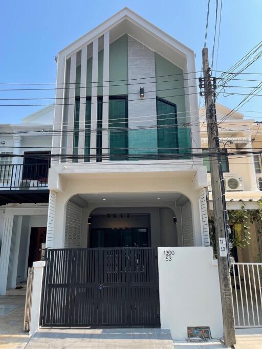 Modern two-story house with a large gate