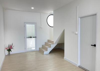 Bright and modern interior space with staircase and laminate flooring