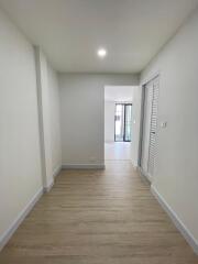 Bright and spacious corridor leading to a well-lit room