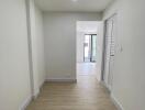 Bright and spacious corridor leading to a well-lit room