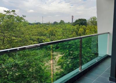 Balcony with a view of greenery and clear skies