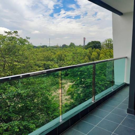 Balcony with a view of greenery and clear skies