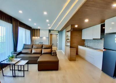 Open concept living room with adjoining kitchen