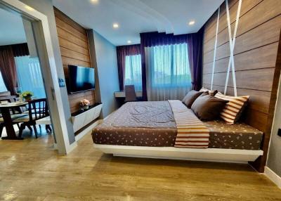 Modern bedroom with open layout connecting to living area
