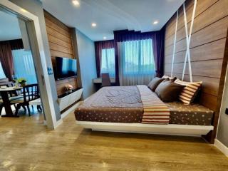 Modern bedroom with open layout connecting to living area