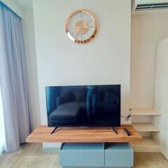 Modern living room with mounted television and wooden furniture