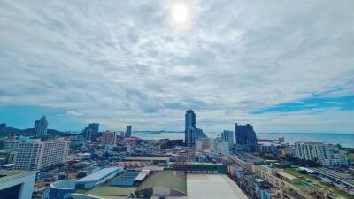 Panoramic cityscape with ocean view under blue skies