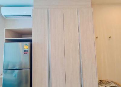 Modern kitchen with stainless steel refrigerator and wooden cabinetry