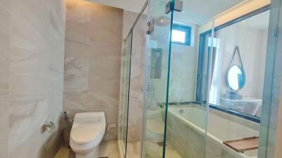 Modern bathroom with bathtub and glass shower enclosure