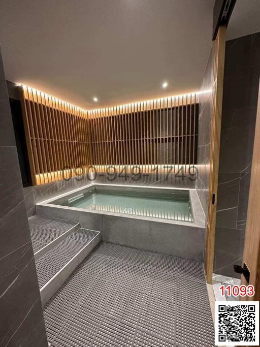 Modern bathroom with integrated lighting and a large bathtub