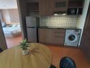 Contemporary studio apartment with integrated kitchen, dining area, and sleeping quarters