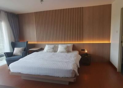 Modern bedroom with LED accent lighting and hardwood flooring