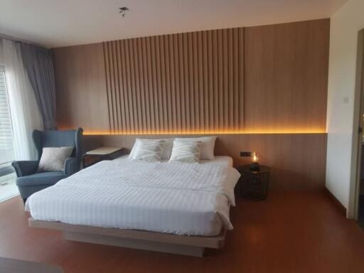 Modern bedroom with LED accent lighting and hardwood flooring