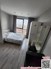 Compact bedroom with a single bed, large window, and wardrobe